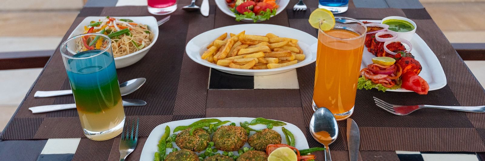 Table set with a variety of starters and refreshing beverages at DLS The Classio